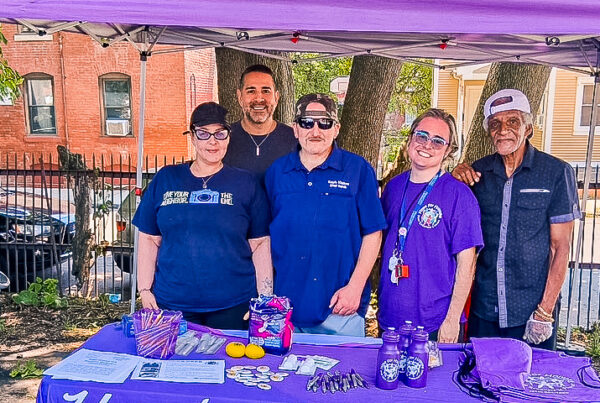 Hope for Holyoke representatives educate the public on peer recovery support services outside Kate's Kitchen, with Providence Ministries team members.